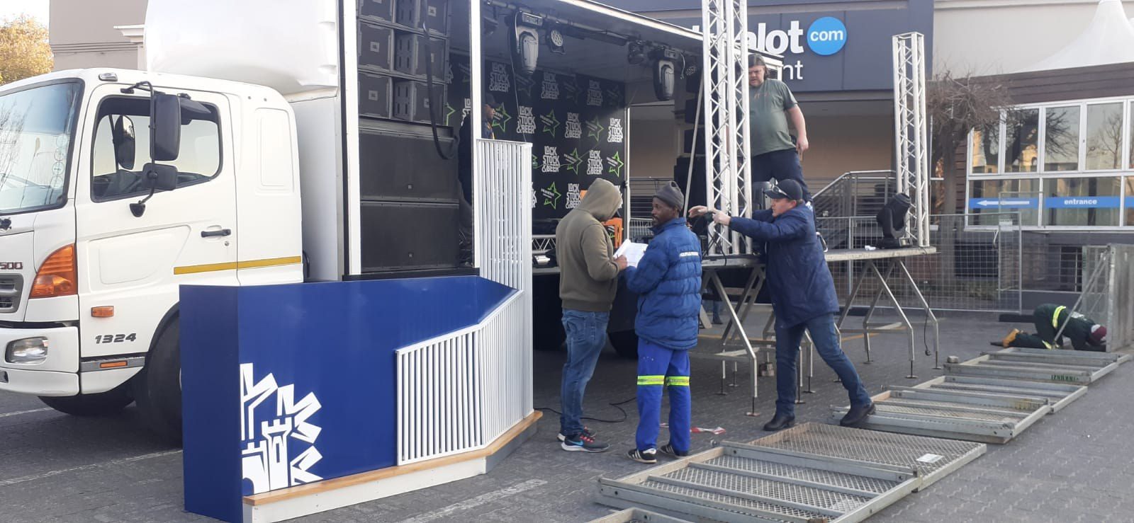 Behind the scenes: crew offloading a truck during a stage build