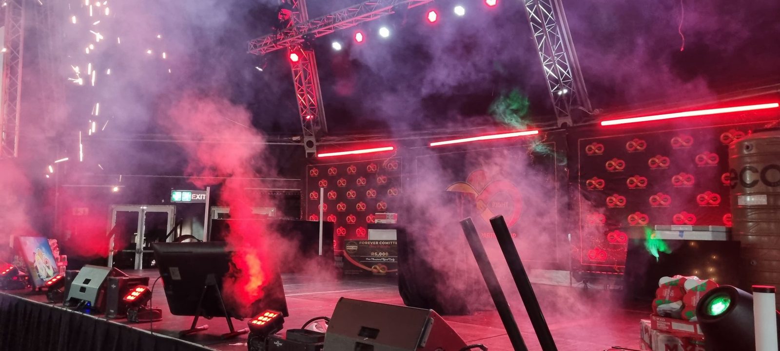 Stage truss with moving-head lights, sparklers and smoke