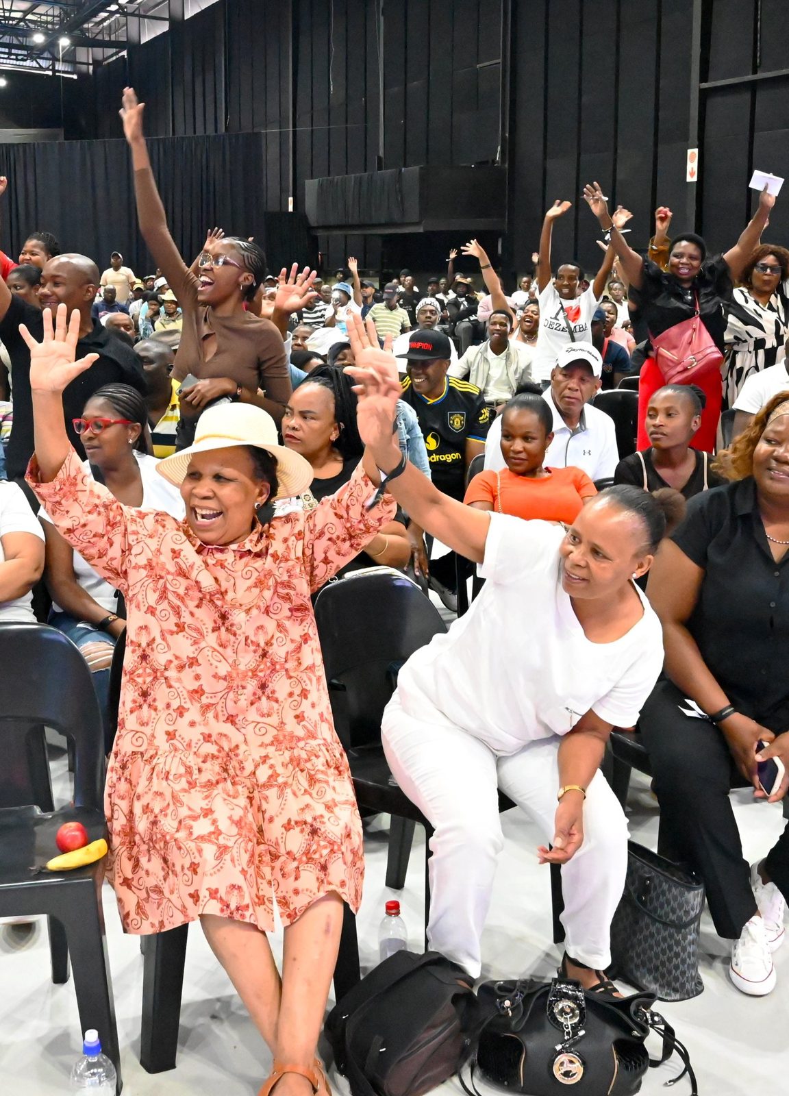 Crowd cheering with hands in the air at a B&W Productions event