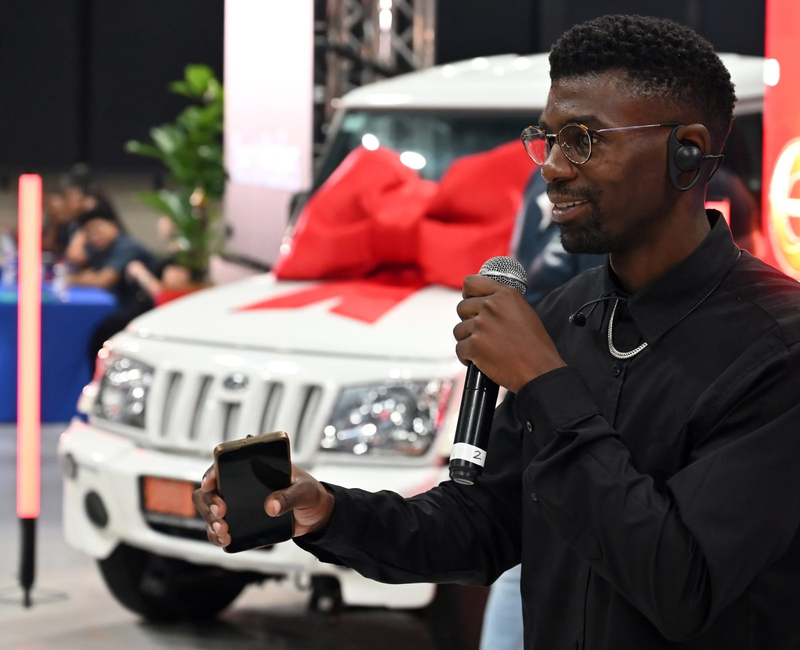 MC with microphone on stage at a launch event