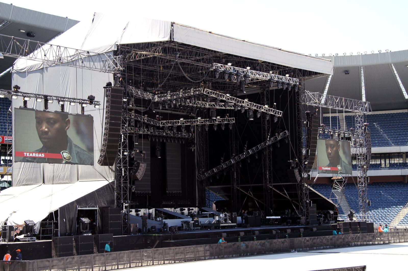 Large stage and lighting rig at a stadium event